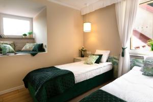 Posteľ alebo postele v izbe v ubytovaní Apartamenty Willove Wzgórze