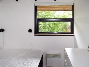 a bedroom with a bed and a window at 4 person holiday home in Slagelse in Slagelse