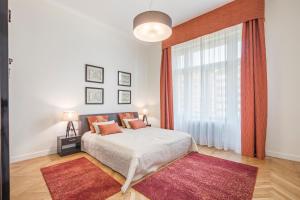 a bedroom with a bed and a large window at MODERNIZED Unique Huge Central Apartment On 135sqm in Budapest