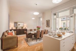 a kitchen and dining room with a table and chairs at MODERNIZED Unique Huge Central Apartment On 135sqm in Budapest