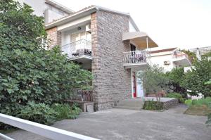 a brick house with two balconies on the side of it at Apartments Nada in Budva