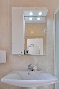 a bathroom with a sink and a mirror at Apartments Nada in Budva