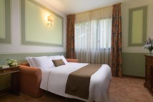 Postel nebo postele na pokoji v ubytování Hotel San Gregorio