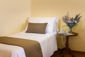 Postel nebo postele na pokoji v ubytování Hotel San Gregorio
