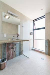 a bathroom with a sink and a glass door at Geneseo Inn in Paso Robles