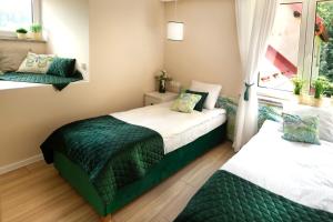 Posteľ alebo postele v izbe v ubytovaní Apartamenty Willove Wzgórze