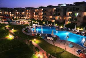 a view of a swimming pool at night at Nice view in ‘Izbat Abū Sulayman +41 photos