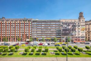 a large building with a parking lot in a city at MODERNIZED Unique Huge Central Apartment On 135sqm in Budapest