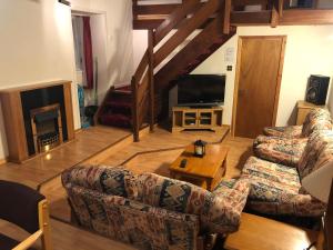 a living room with two couches and a television at Cosy holiday home, Scalloway, Shetland. in Scalloway