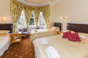 a hotel room with two beds and a window at Brae Guest House in Edinburgh