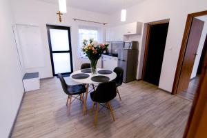 a kitchen and dining room with a table and chairs at Apartament u Andrzeja in Polanica-Zdrój