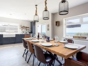 a kitchen and dining room with a wooden table and chairs at Beach Haven in Dorchester