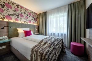 Postel nebo postele na pokoji v ubytování Boutique Hotel Erb München Parsdorf