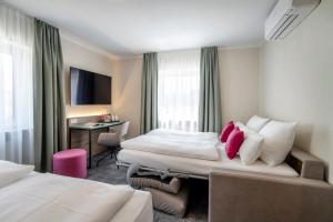 TV a/nebo společenská místnost v ubytování Boutique Hotel Erb München Parsdorf