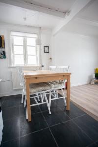 a dining room with a wooden table and chairs at Two Bedroom Vacation Home in the Center of Tórshavn in Tórshavn