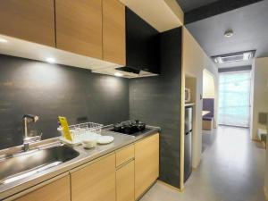 a kitchen with a sink and a counter top at Hotel S-Presso South in Osaka