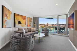 a living room with a couch and a table at Pullman Quay Grand Sydney Harbour in Sydney