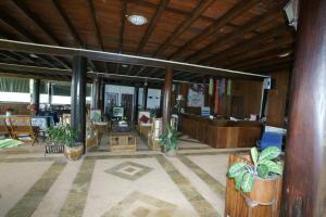 a living room with a lobby with potted plants at Ruen Thai Rim Haad in Klaeng