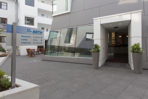 an entrance to an office building with two potted plants at Hotel Barth in Kaiserslautern