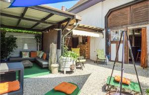 a patio with a couch and an umbrella at Stunning Home In Gottmadingen With 4 Bedrooms And Wifi in Gottmadingen