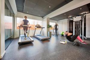 a group of people exercising in a gym at Zleep Hotel Copenhagen Airport in Copenhagen