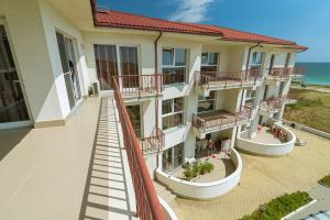 an apartment building with balconies overlooking the ocean at Amphora Vibes in Vama Veche +23 photos