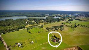 an aerial view of a park with a white circle at Mazurski dom Brejdyny Sauna i Bania in Mrągowo