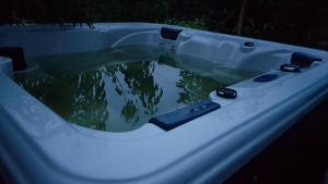 a bath tub filled with a pool of water at Nostravila in Lonavala