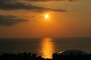 - un coucher de soleil sur l'océan et le ciel dans l'établissement Roconia Terrace, à Motobu