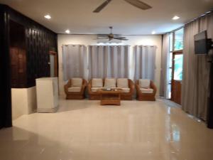 - un salon avec un canapé et des chaises dans l'établissement คุ้งน้ำ รีสอร์ท นครนายก, à Ban Khao Kariang (1)