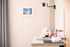 a white desk with a sink and a mirror at So Close Kapana - 2 Rooms Central Apartments in Plovdiv +26 photos