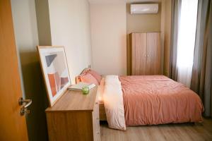 a bedroom with a bed and a table with a picture at So Close Kapana - 2 Rooms Central Apartments in Plovdiv