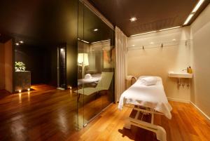 a room with a bed, a chair, and a table in it at Hotel Miró in Bilbao
