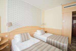 Postel nebo postele na pokoji v ubytování Hotel Orion Várkert