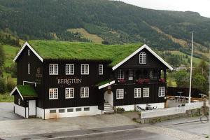 a black and white building with a grass roof at Bergtun Hotell in Valle