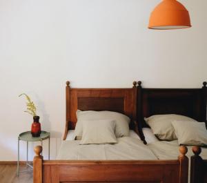 a bedroom with a wooden bed with an orange lamp at Bahnhof 123 in Fridingen an der Donau