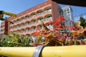 a building with a bunch of flowers in front of it at Балнеохотел "Гергана" in Hisarya