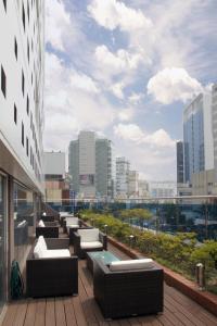 a row of couches on a balcony of a building at Hotel Foret Premier Nampo in Busan