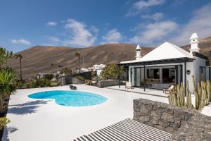 a swimming pool in a backyard with a house at La Cabaña in La Asomada