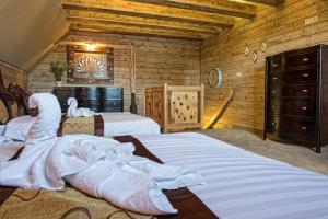a bedroom with two beds and a towel on the bed at Mountain Resort Ždiar - River in Ždiar