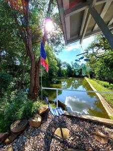 a flag next to a pond in a garden at Fisherman's Cottage in Cacica