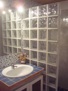 a bathroom with a sink and a glass wall at Impressive in ground floor with terrace of 2 rooms and pool in Playas de Vera