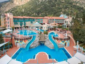 
a swimming pool with a pool table and chairs at Liberty Lykia Adults Only in Oludeniz
