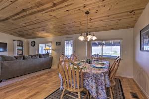 a dining room with a table and chairs and a couch at Rustic Bullhead City Retreat with Porch and Views in Bullhead City