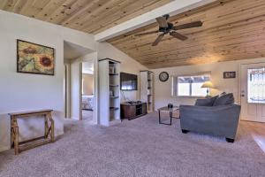 a living room with a ceiling fan and a couch at Rustic Bullhead City Retreat with Porch and Views in Bullhead City
