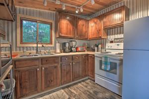 a kitchen with wooden cabinets and a white refrigerator at Pequot Lakes Cabin with Dock Nestled on Loon Lake! in Pequot Lakes
