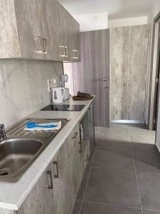 a kitchen with a sink and a counter top at ElleNapa Apts & Studios in Ayia Napa