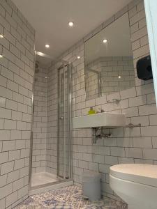 a bathroom with a shower and a sink and a toilet at St Athans Hotel in London