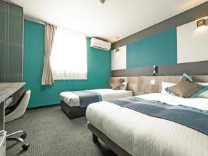 Postel nebo postele na pokoji v ubytování Hotel Areaone Tokai