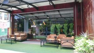 a lobby with chairs and tables in front of a building at Sokdee City Hotel in Vientiane